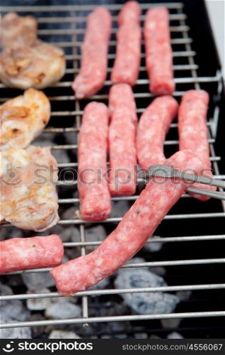 Sausages and chicken cooking on the barbecue