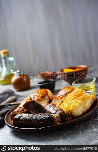 Sausages and fish, chicken fried with spices and herbs, Selective focus. Sausages, chicken, fish fried with spices and herbs, Selective focus