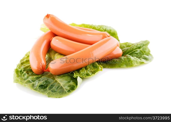 Sausages and lettuve leaves isolated on white background.