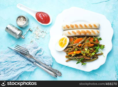 sausages and vegetables for dinner on plate