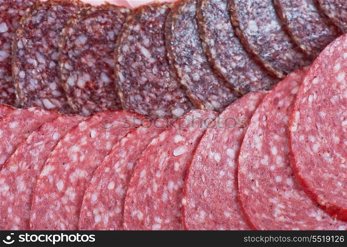 Sausages background with many sliced