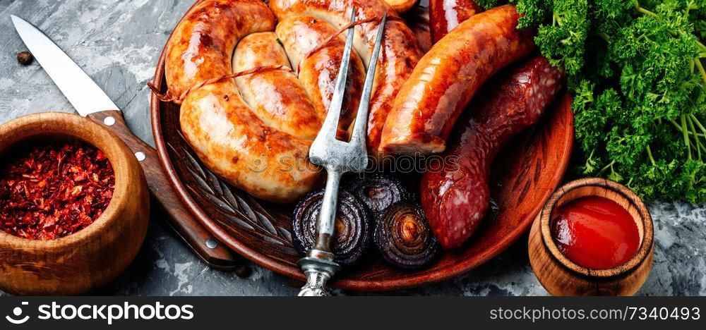 Sausages fried with spices and herbs.Grilled spiral sausages. Barbecued pork sausages