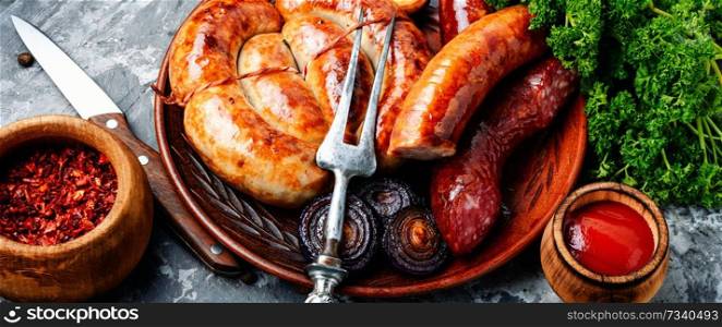 Sausages fried with spices and herbs.Grilled spiral sausages. Barbecued pork sausages