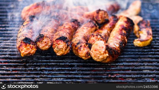 Sausages grilled on a charcoal barbeque. Top view of tasty barbecue, food concept, food on grill and detail of sausages on the grill