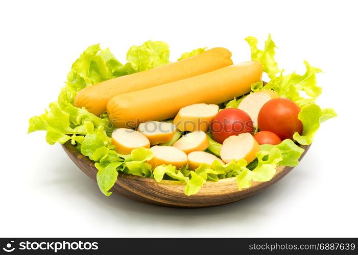 Sausages, lettuce and tomatoes in wooden bowl on white background