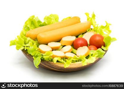 Sausages, lettuce and tomatoes in wooden bowl on white background
