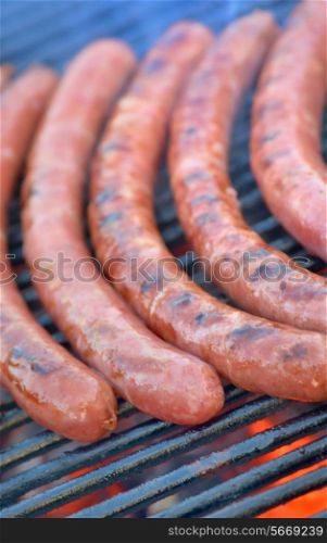 Sausages on a grill outdoor.