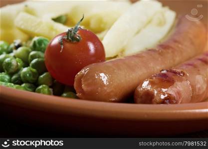 Sausages with french fries and vegetables