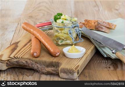 Sausages with mustard and potato salad. Sausages with mustard and potato salad.