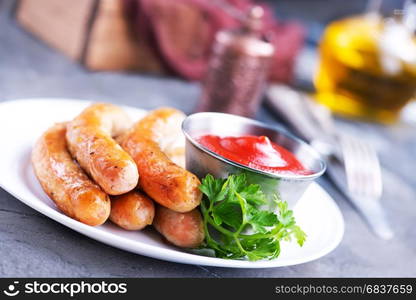 sausages with sauce on plate, stock photo