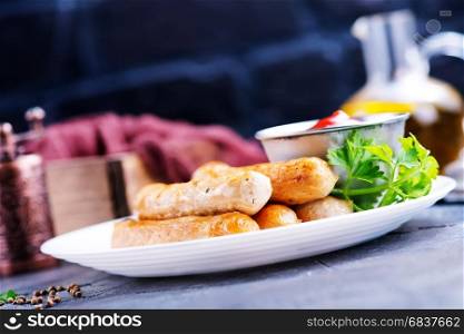 sausages with sauce on plate, stock photo