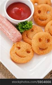 sausages with smiling potatoes. sausages with smiling potatoes and tomato sauce