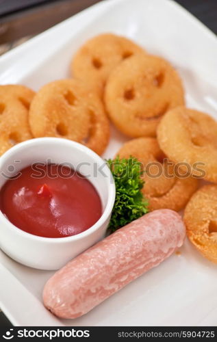 sausages with smiling potatoes. sausages with smiling potatoes and tomato sauce