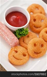 sausages with smiling potatoes. sausages with smiling potatoes and tomato sauce
