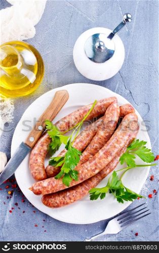 sausages with spice on white plate. stock photo