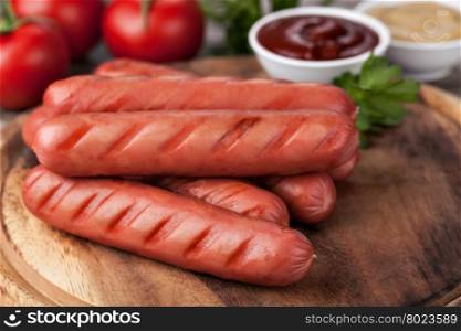 sausages. wooden Plate with hot sausages