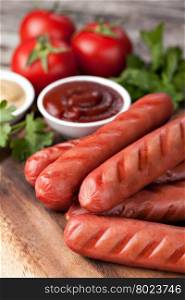sausages. wooden Plate with hot sausages