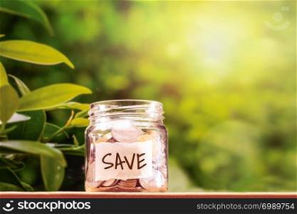 save money, coins in glass jar for money saving financial concept