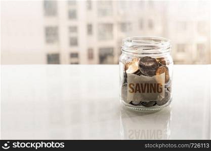 save money, coins in glass jar for money saving financial concept