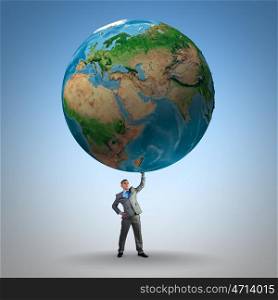Save our planet. Businessman holding huge Earth planet above head. Elements of this image are furnished by NASA