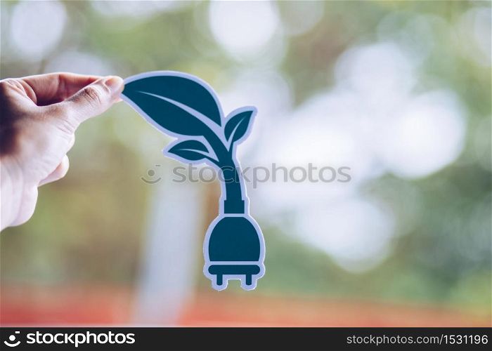 save world ecology concept environmental conservation with hands holding cut out paper power plug showing