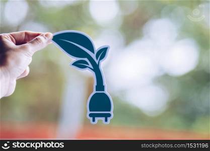 save world ecology concept environmental conservation with hands holding cut out paper power plug showing