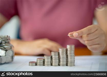 Saving money. Businessman Accountant verify growing business and saving money stacking coins with calculator. Accountancy Concept