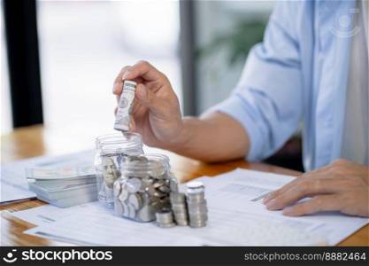 Saving money. Businessman Accountant verify growing business and saving money stacking coins with calculator. Accountancy Concept 