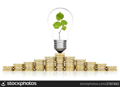 Saving money concept. Bulb and coins stacked on white background