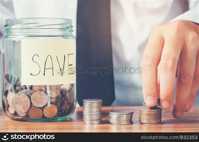 Saving money concept Man hand putting Row and coin Write Finance