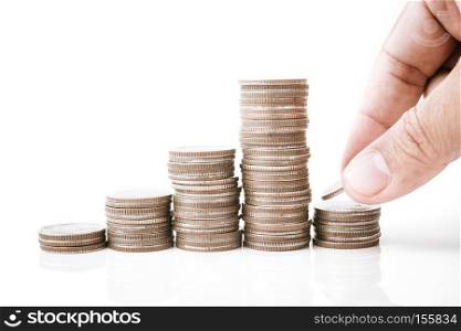 saving money, hand putting money coin stack on white background