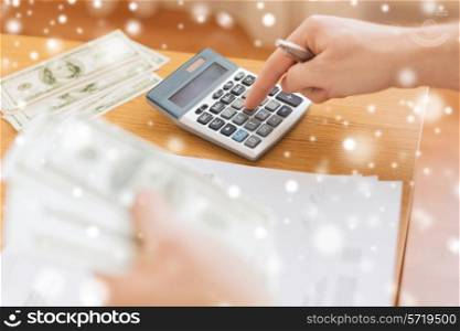savings, finances, paperwork and people concept - close up of man with calculator counting money and making notes at home