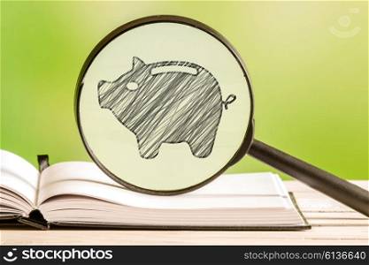 Savings information with a pencil drawing of a piggy bank in a magnifying glass