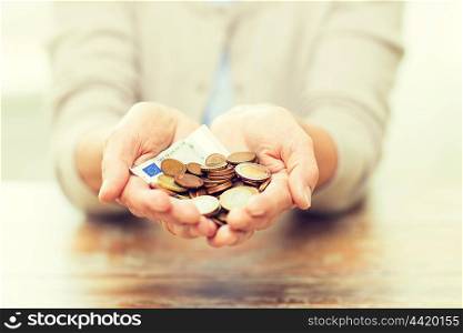 savings, money, annuity insurance, retirement and people concept - close up of senior woman hands holding money jar