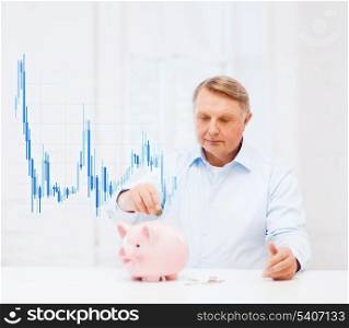 savings, oldness, money, business and banking concept - old man with coin, big piggy bank and forex chart