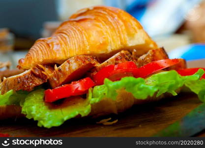 savory croissant brioche bread with chicken breast and vegetable rustic style