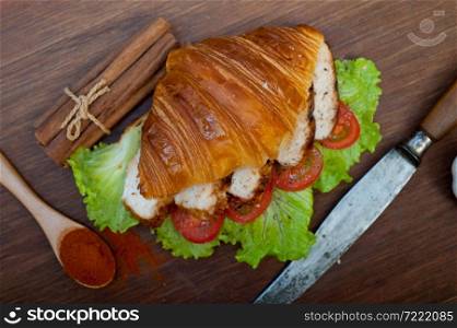 savory croissant brioche bread with chicken breast and vegetable rustic style