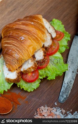 savory croissant brioche bread with chicken breast and vegetable rustic style