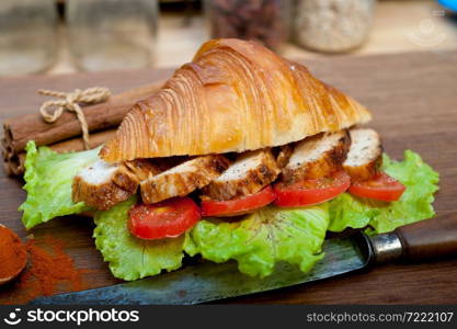 savory croissant brioche bread with chicken breast and vegetable rustic style