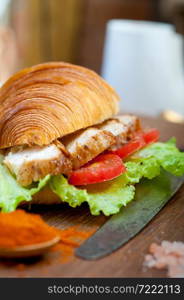 savory croissant brioche bread with chicken breast and vegetable rustic style