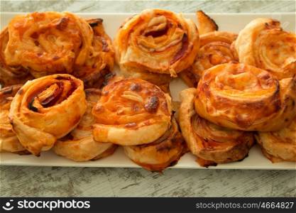Savory puff pastries spiral shaped filled cheese
