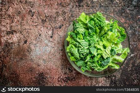 Savoy cabbage salad in a bowl. On rustic background.. Savoy cabbage salad in a bowl.