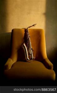 Saxophone musical instrument left on chair in retro room. Musician equipment for jazz performance. Saxophone musical instrument left on chair in retro room