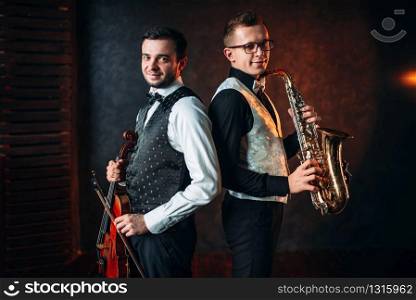 Saxophonist with sax and violinst with violin musical duet. Jazz-man and fiddler