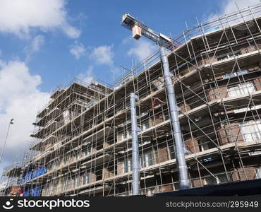 scaffolding around construction site of large building in dutch town of utrecht