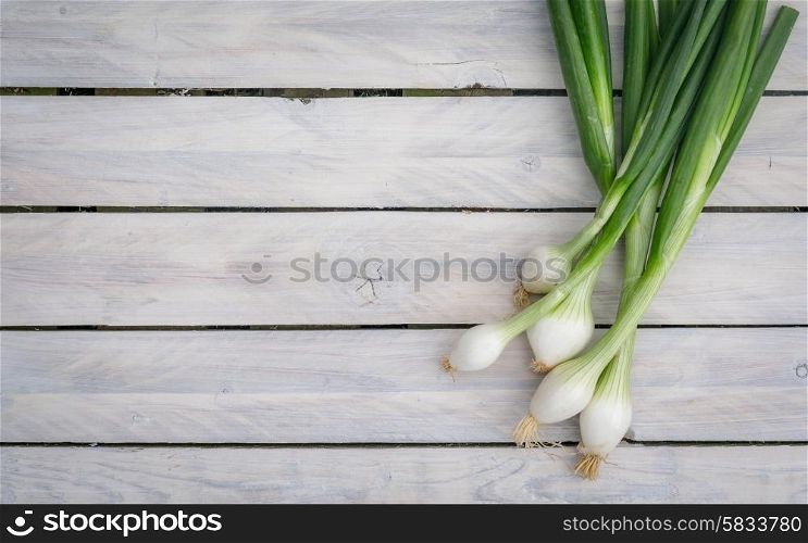 Scallions on a bright wooden table