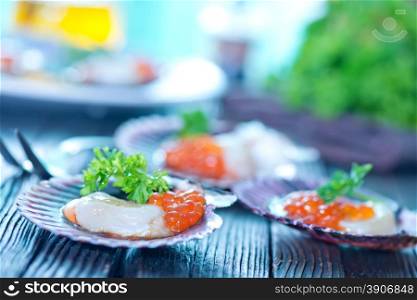 scallop with red caviar on the plate