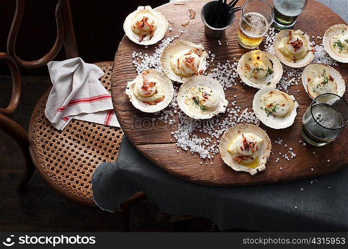 Scallops in shells on table