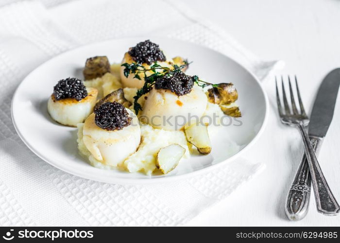 Scallops with black caviar