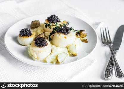 Scallops with black caviar